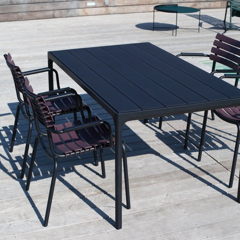 Black dining table with four black dining chairs