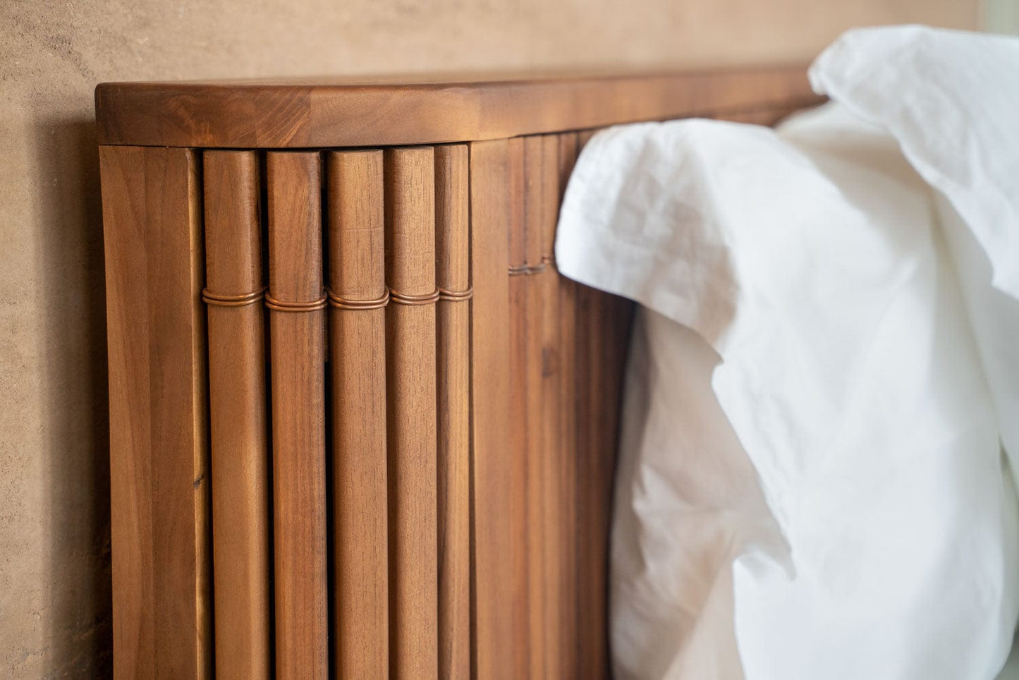 Bamboo bed frame with white bedding