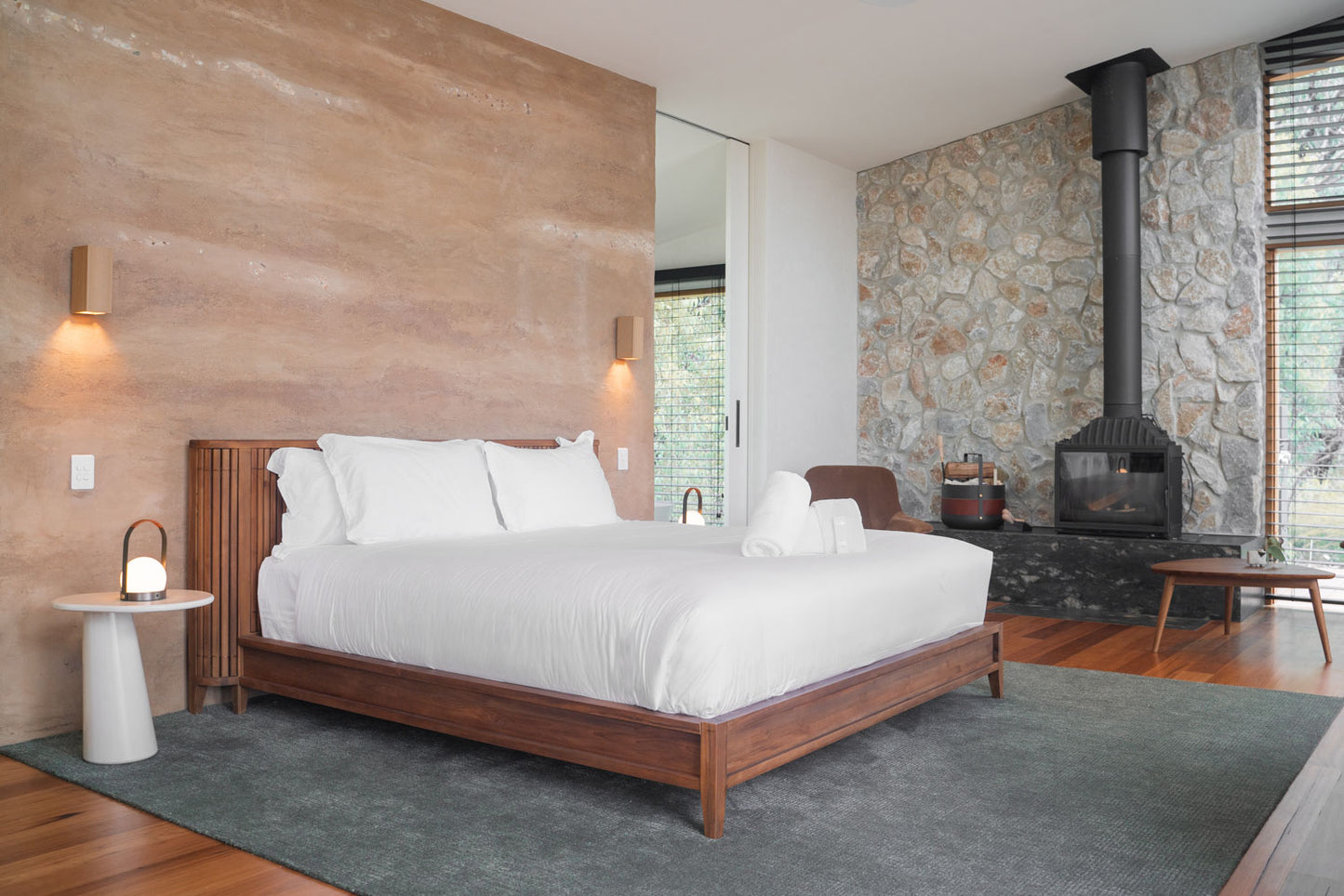 Bedroom with fireplace and wooden bed