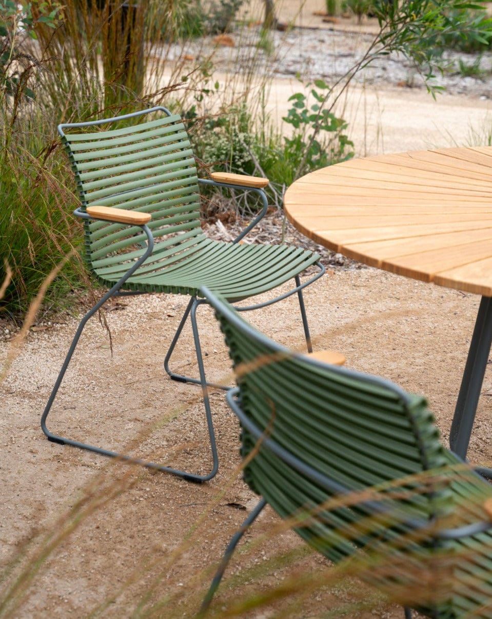 Green outdoor dining chair in garden
