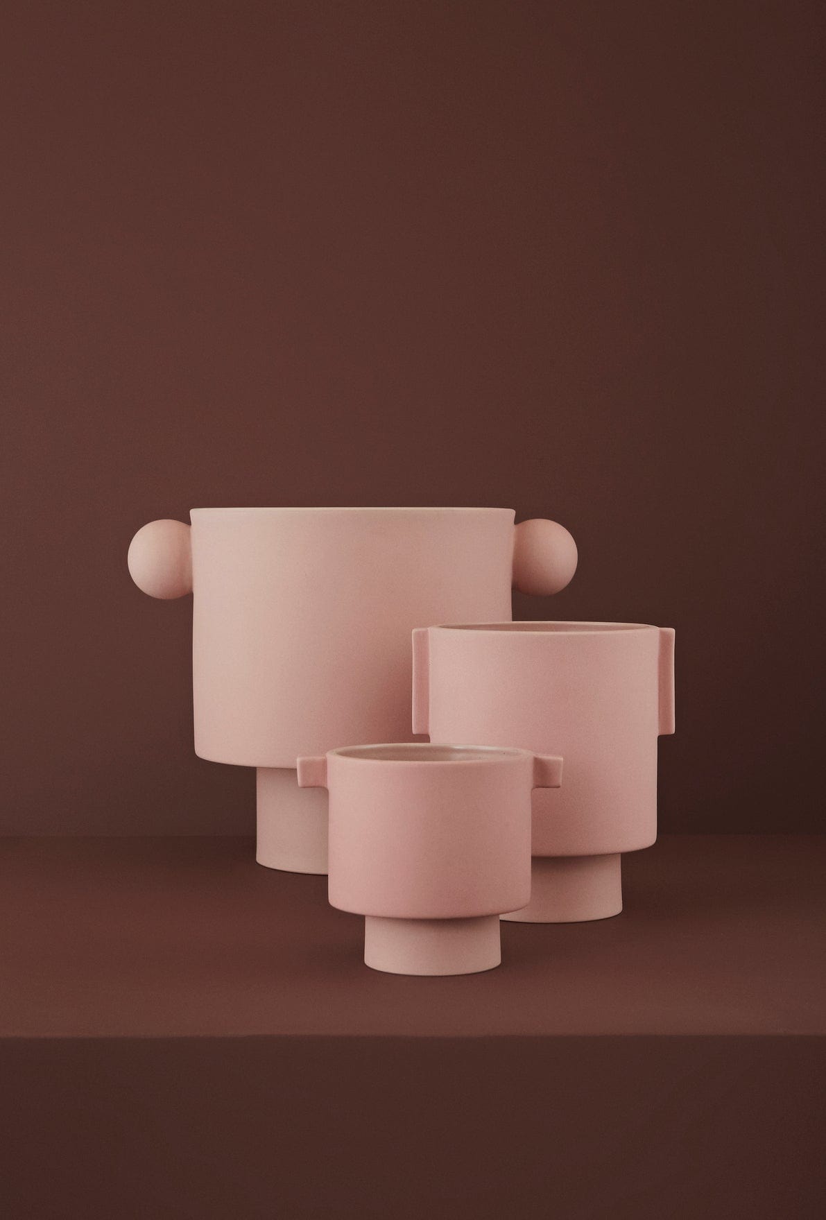 Pink KANASMLMEDLGEROSEGROUP planters in a group.