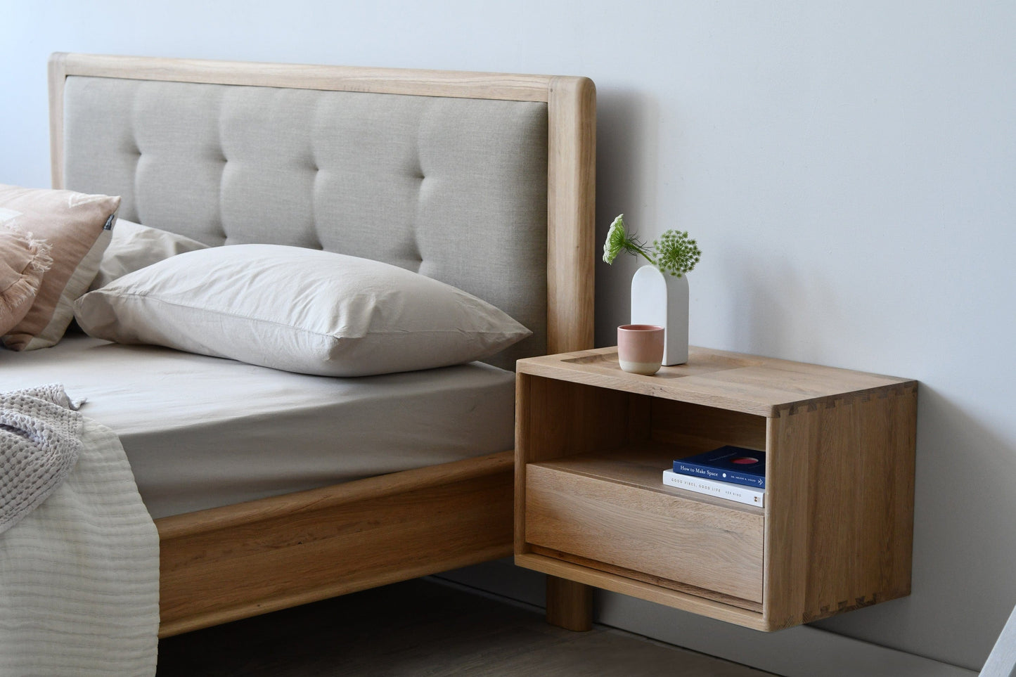 Bedroom with upholstered headboard and wooden nightstand