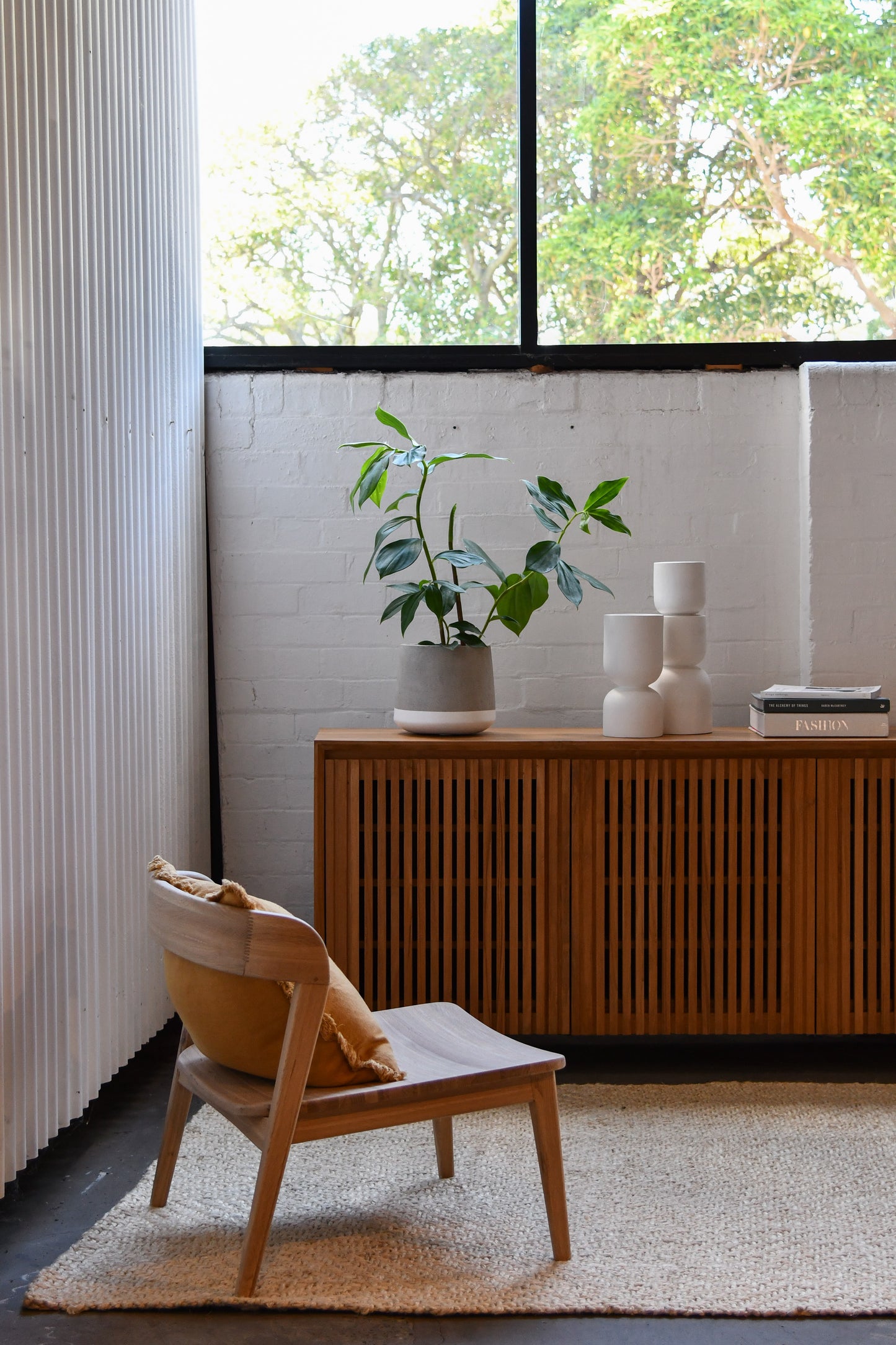 Interior scene with chair, plant, and cabinet
