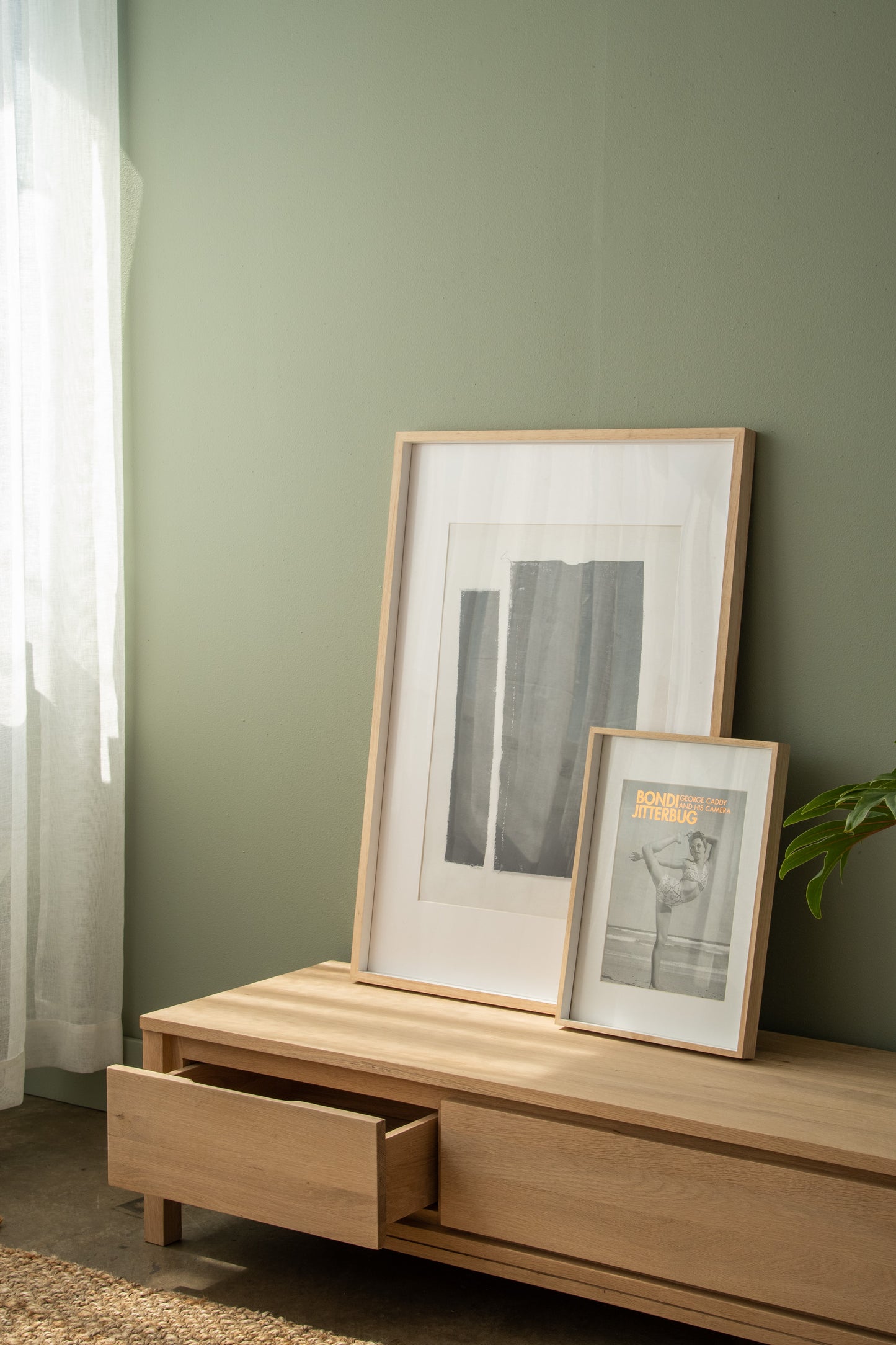 framed art and decor on wooden cabinet