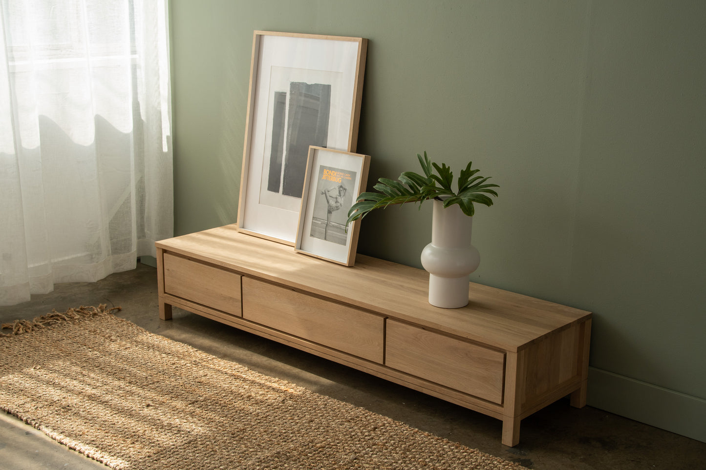 Wooden TV stand with art and vase