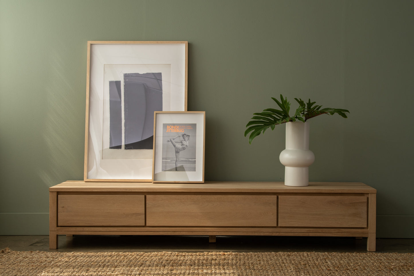 Modern wood TV stand with art and vase