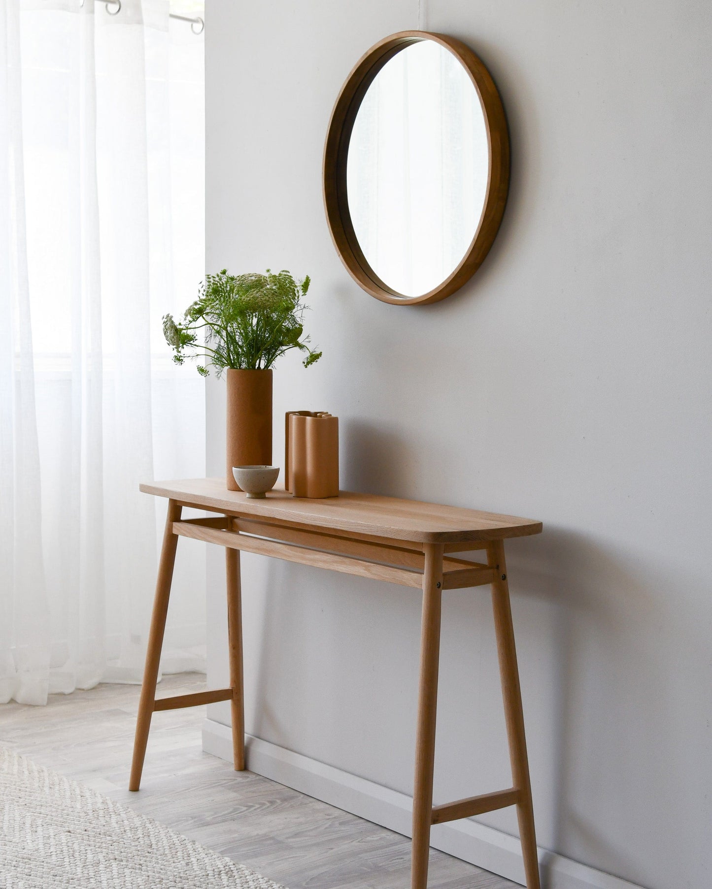 Wooden console table with mirror and decor