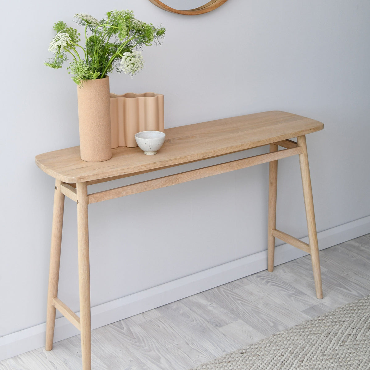 Wooden console table with decor and flowers