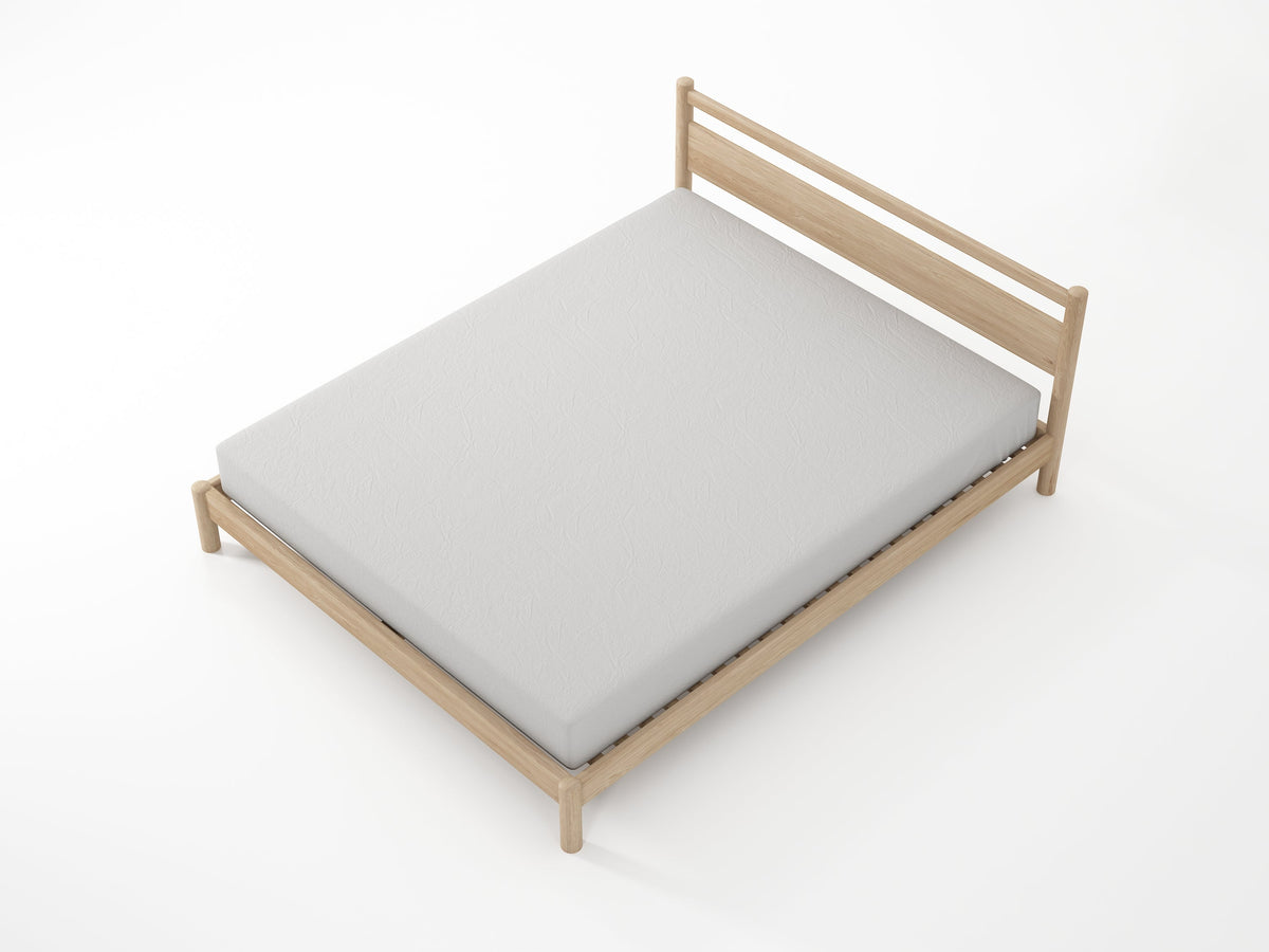Wooden bed frame with a gray mattress