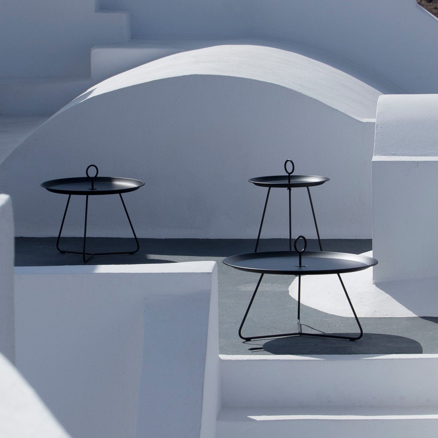 Modern black side tables on white steps