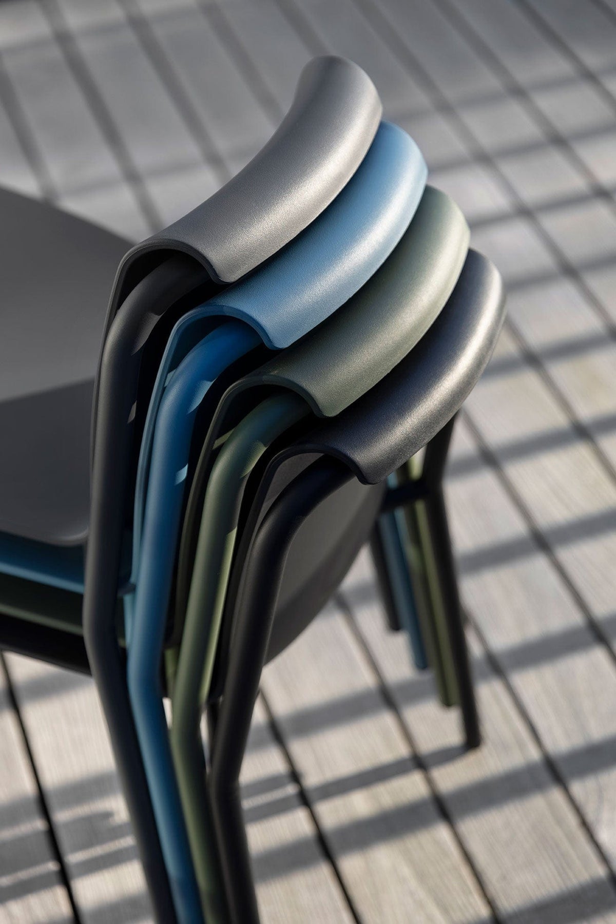 Stacked NAMI chairs in various colors