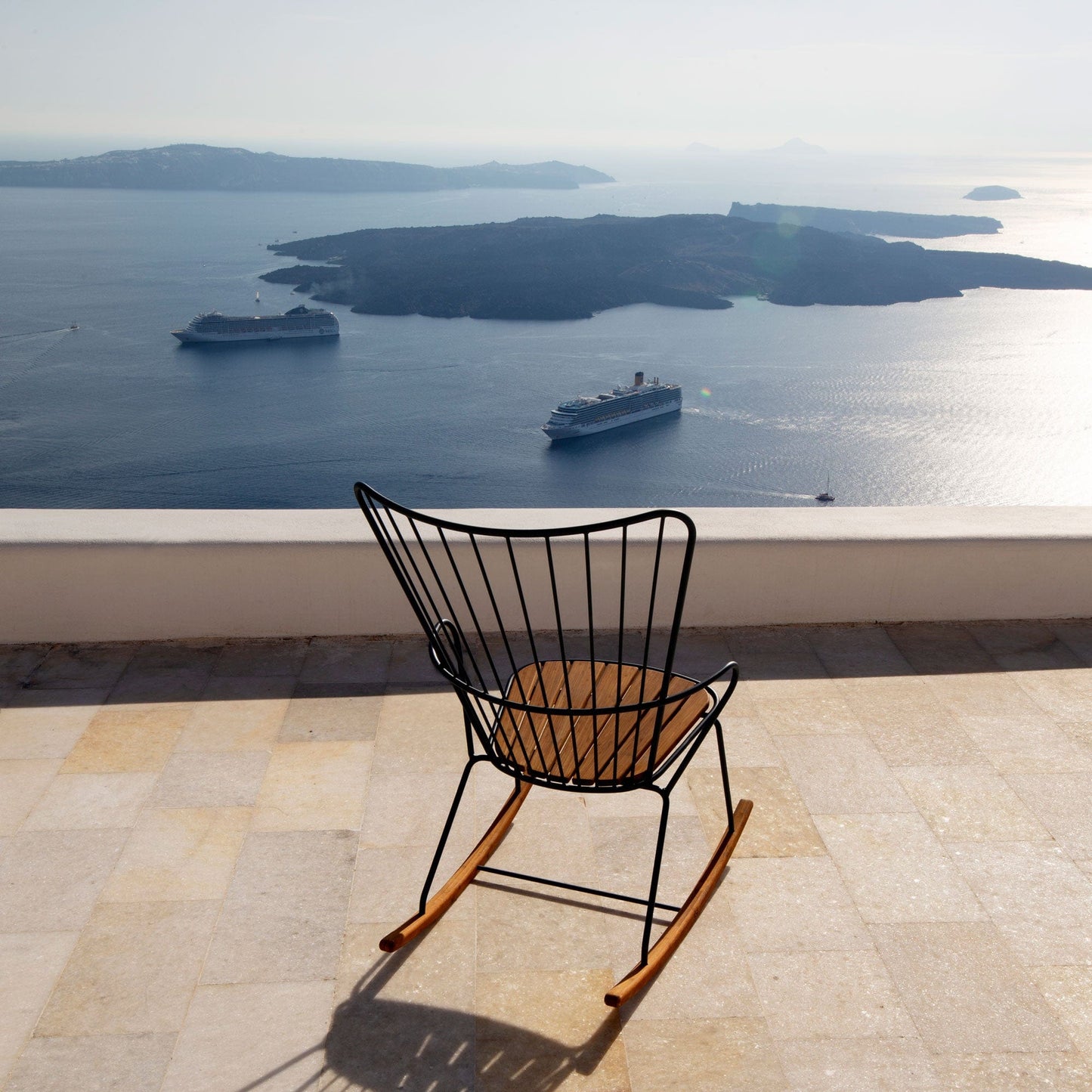 PAON rocking chair overlooking Santorini with cruise ships