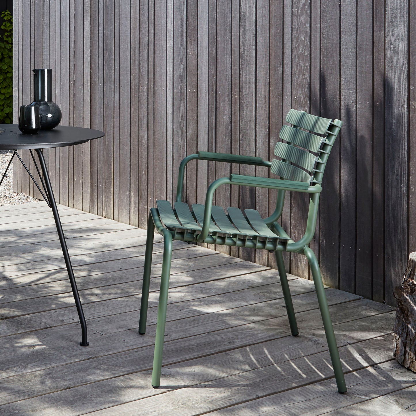 Green outdoor dining chair made from recycled plastic.