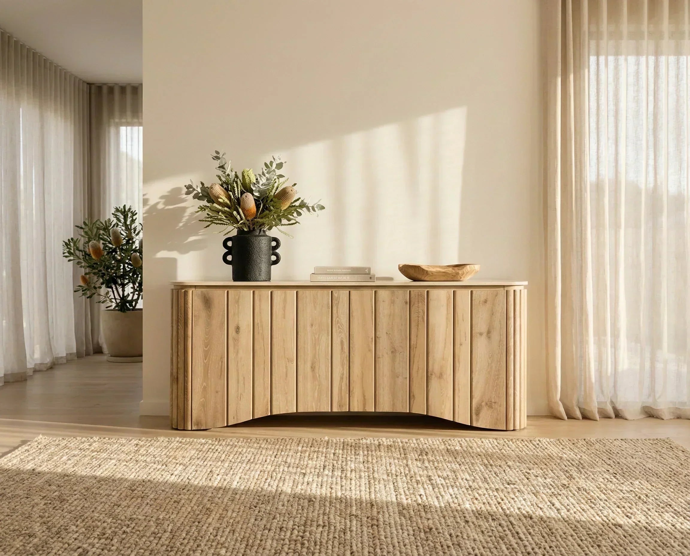 Minimalist oak sideboard styled with native botanicals in a warm neutral living room
