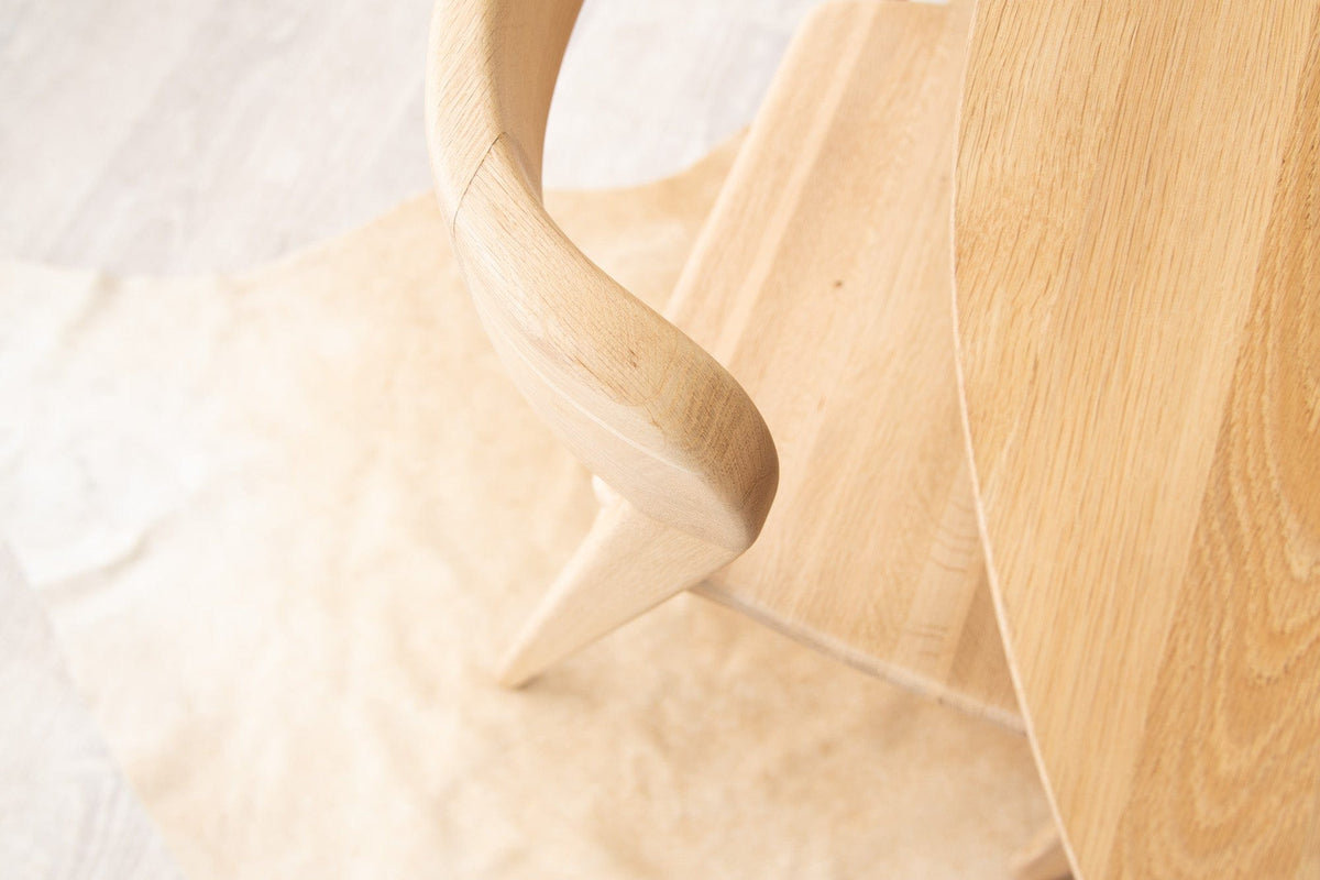 Wooden chair leg and seat detail.