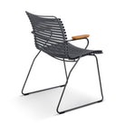Gray metal chair with wooden armrest.