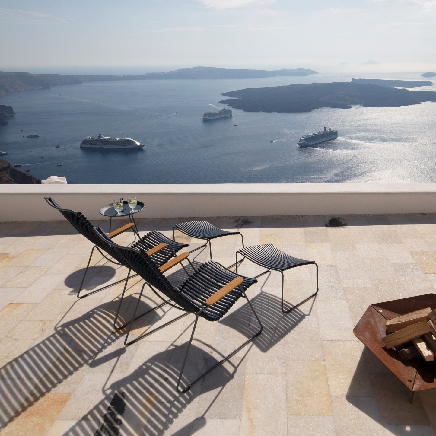 Chairs overlooking Santorini with cruise ships, 2018