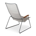 Modern gray and white lounge chair with wood armrest.