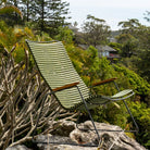 Green outdoor chair on a rock.