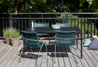 Outdoor table and chairs on a wooden deck.