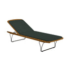 Outdoor chaise lounge with green cushion.