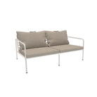 Two-seat outdoor sofa with beige cushions.