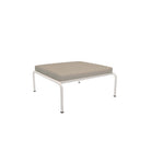 Square ottoman with beige cushion and white frame.