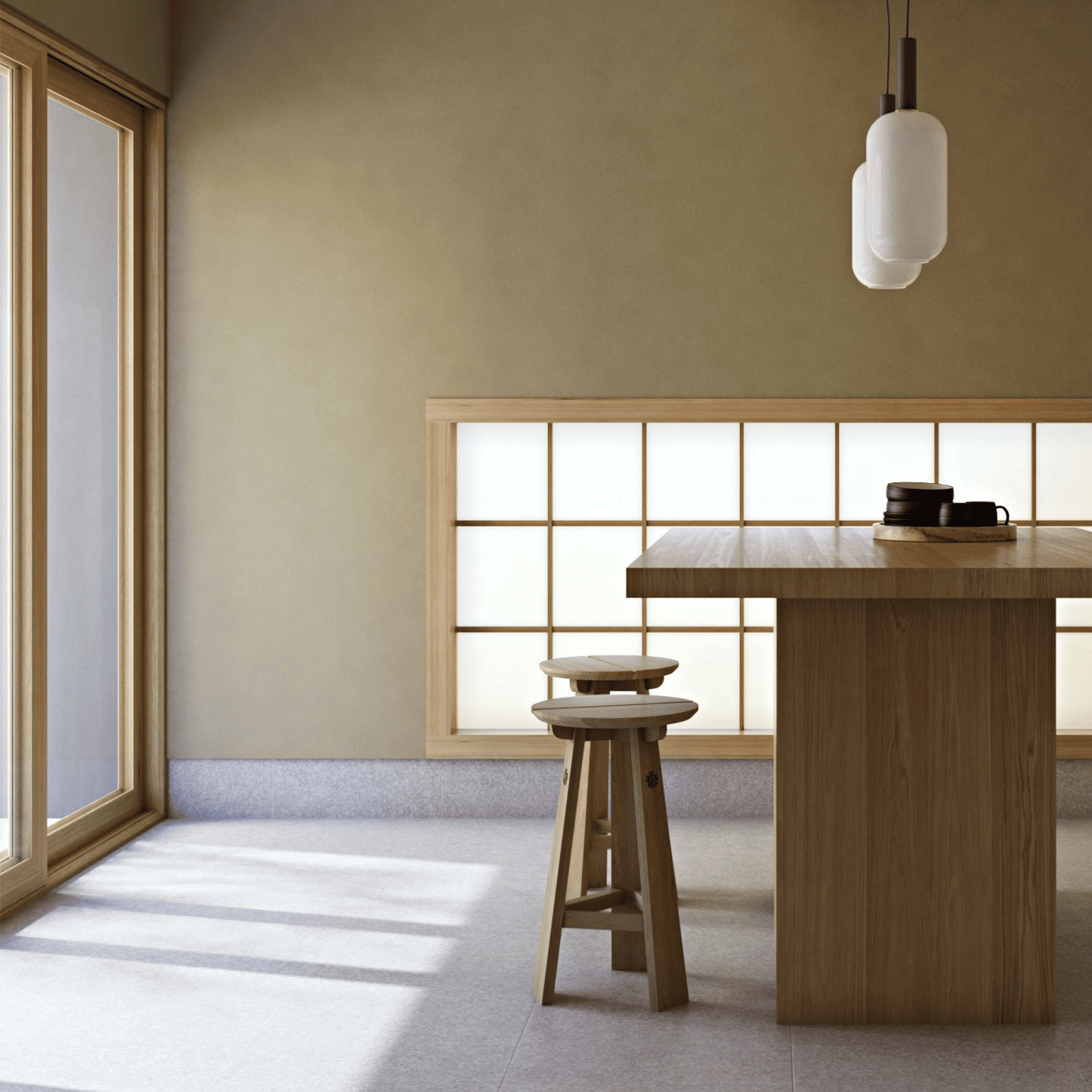 Interior with wooden table, stools, and pendant light.
