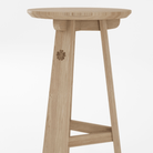 Wooden stool with floral carving.