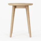 Wooden round side table on white background.