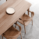 Wooden table with chairs and a plate.