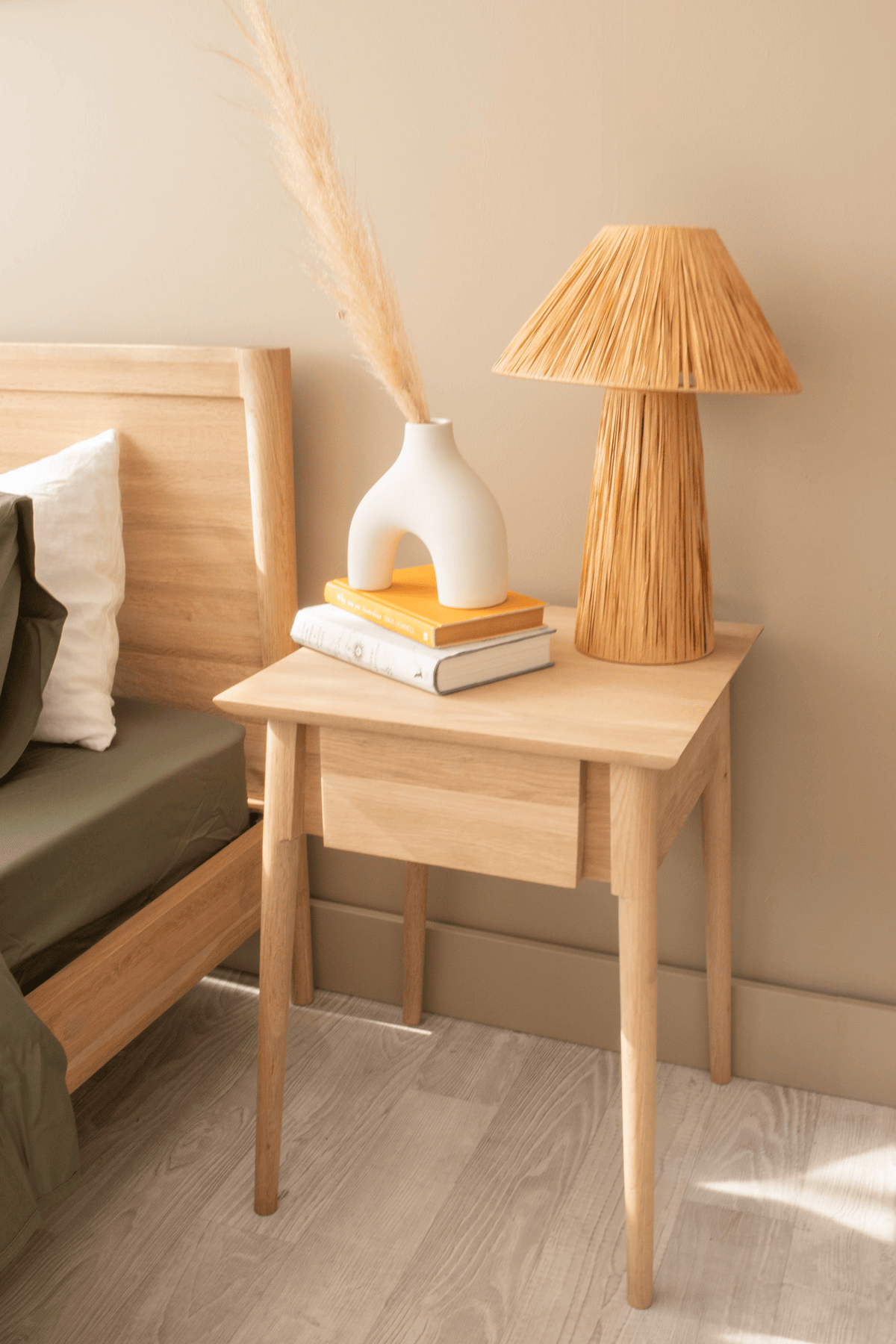 Nightstand with lamp, books, and vase - c53ccd09