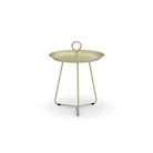 Round, light green side table with handle.