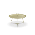 Round, light green metal side table with handle.