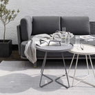 Modern patio furniture with grey sofa and side tables