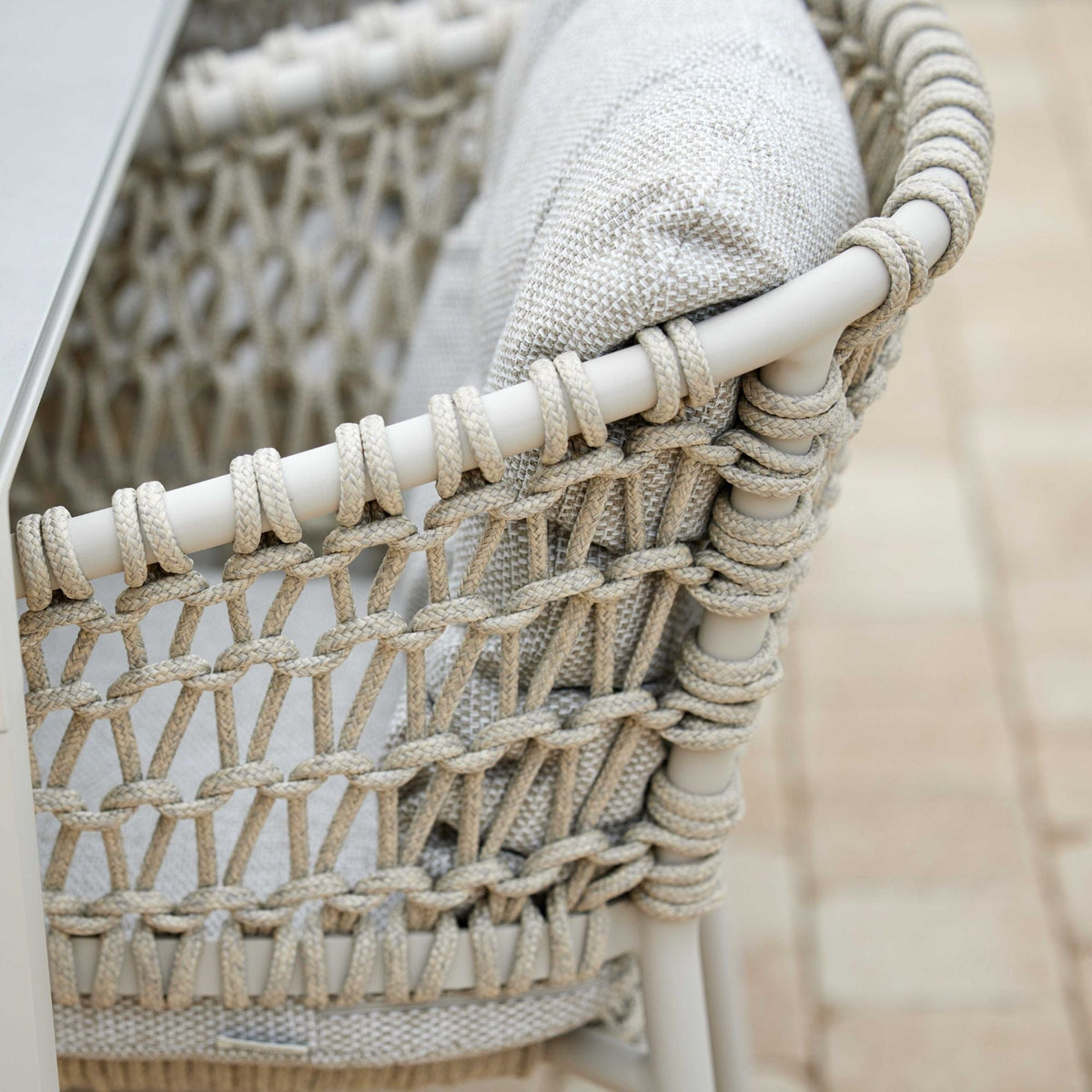Woven outdoor chair with cushion