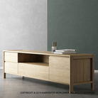 Wooden TV stand with drawers and shelf.