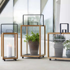 Wooden lanterns with plants and candle