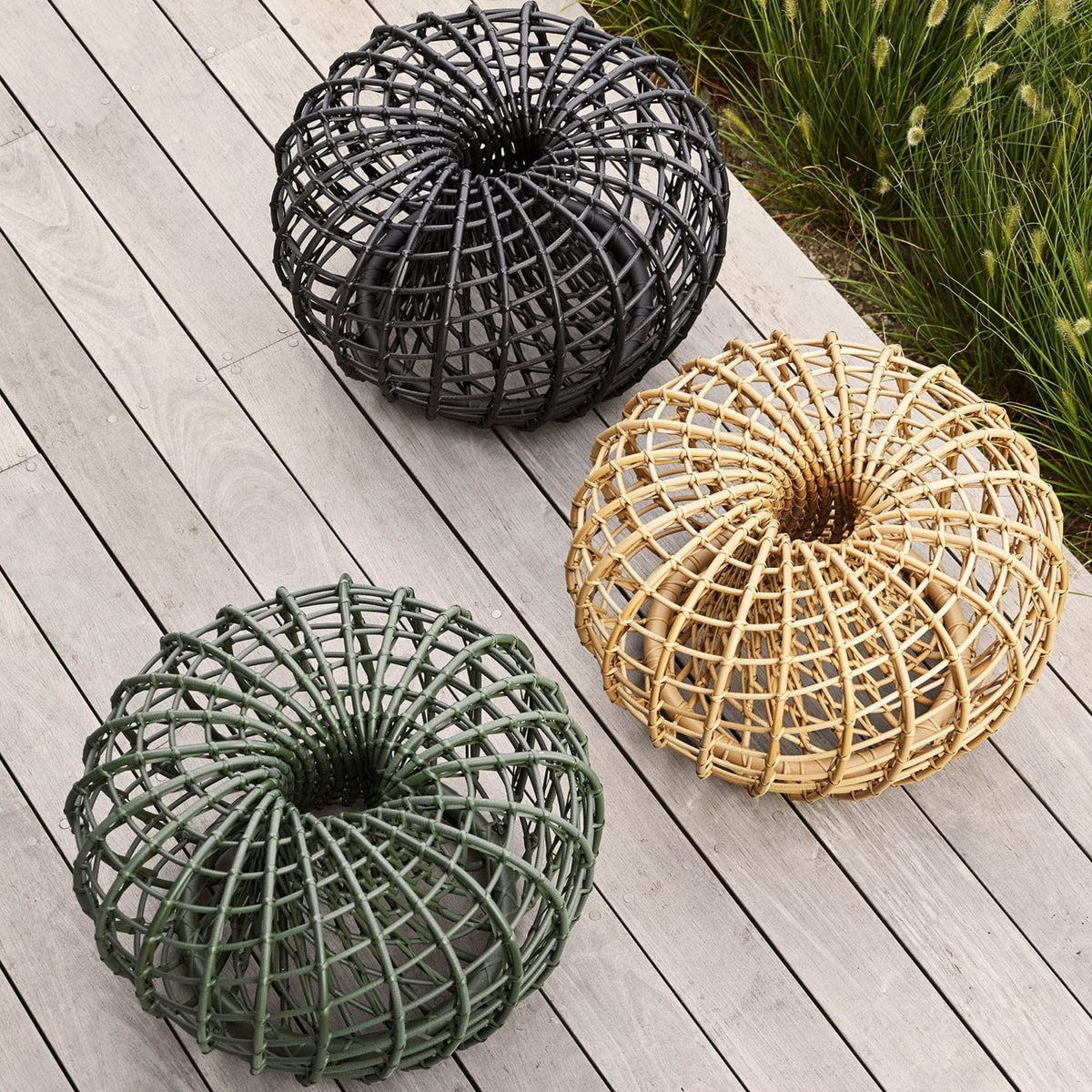 Wicker decorative sphere set on wood deck