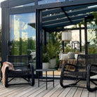 Outdoor seating area with modern black chairs.