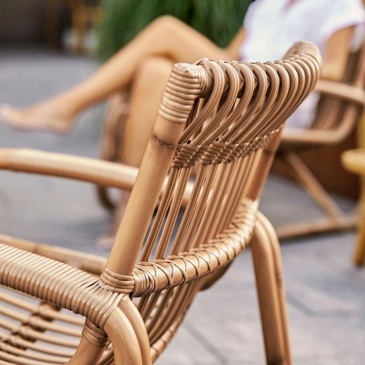Rattan chair with woman relaxing, 57402AUU_3