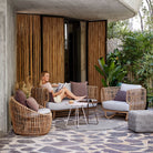 Outdoor wicker furniture set with woman reading