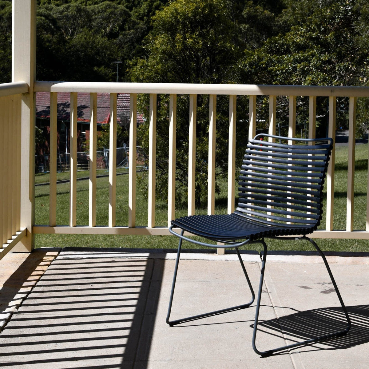 Black outdoor dining chair on patio
