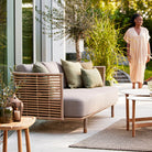 Outdoor sofa with woman in beige dress