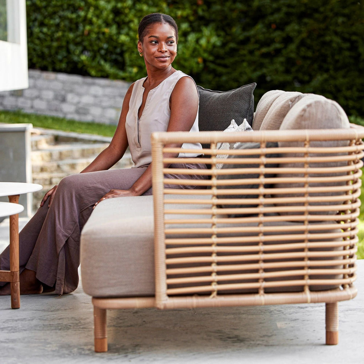 Woman on 7543UAITT_6 rattan sofa