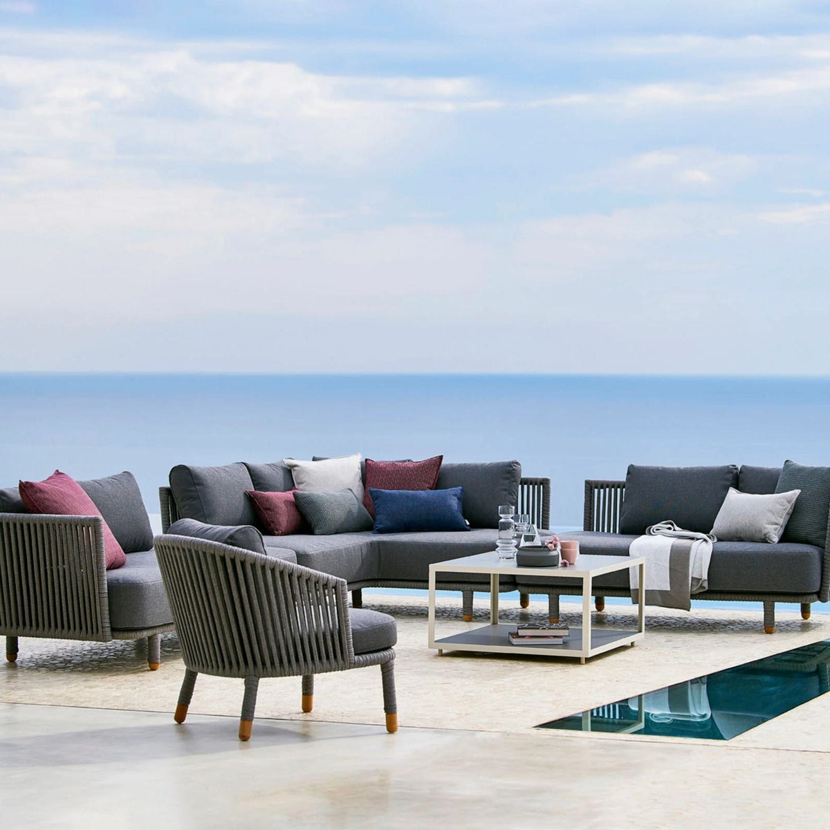 7545ROGAITG_4 outdoor sectional with pillows and coffee table