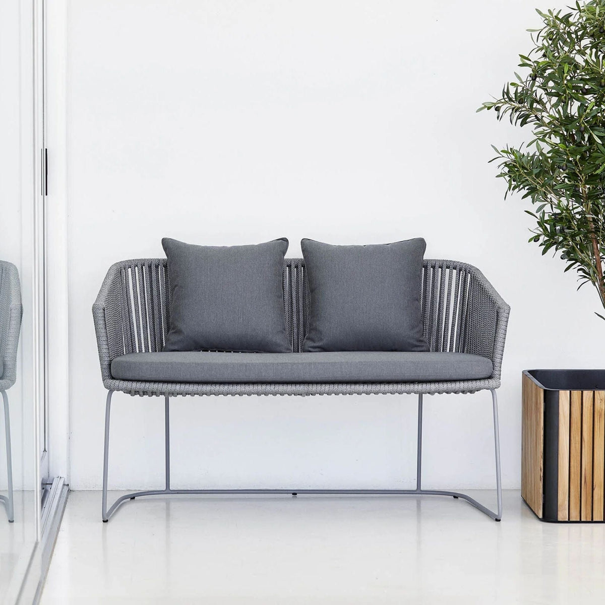Gray outdoor loveseat with cushions