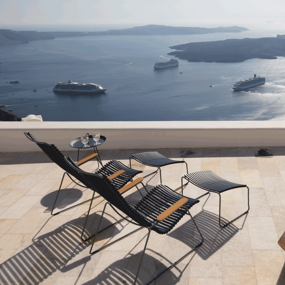 Black footrest on patio with ocean view