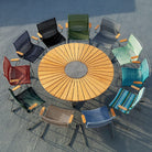 CLICK Dining table with colorful chairs around a circle.