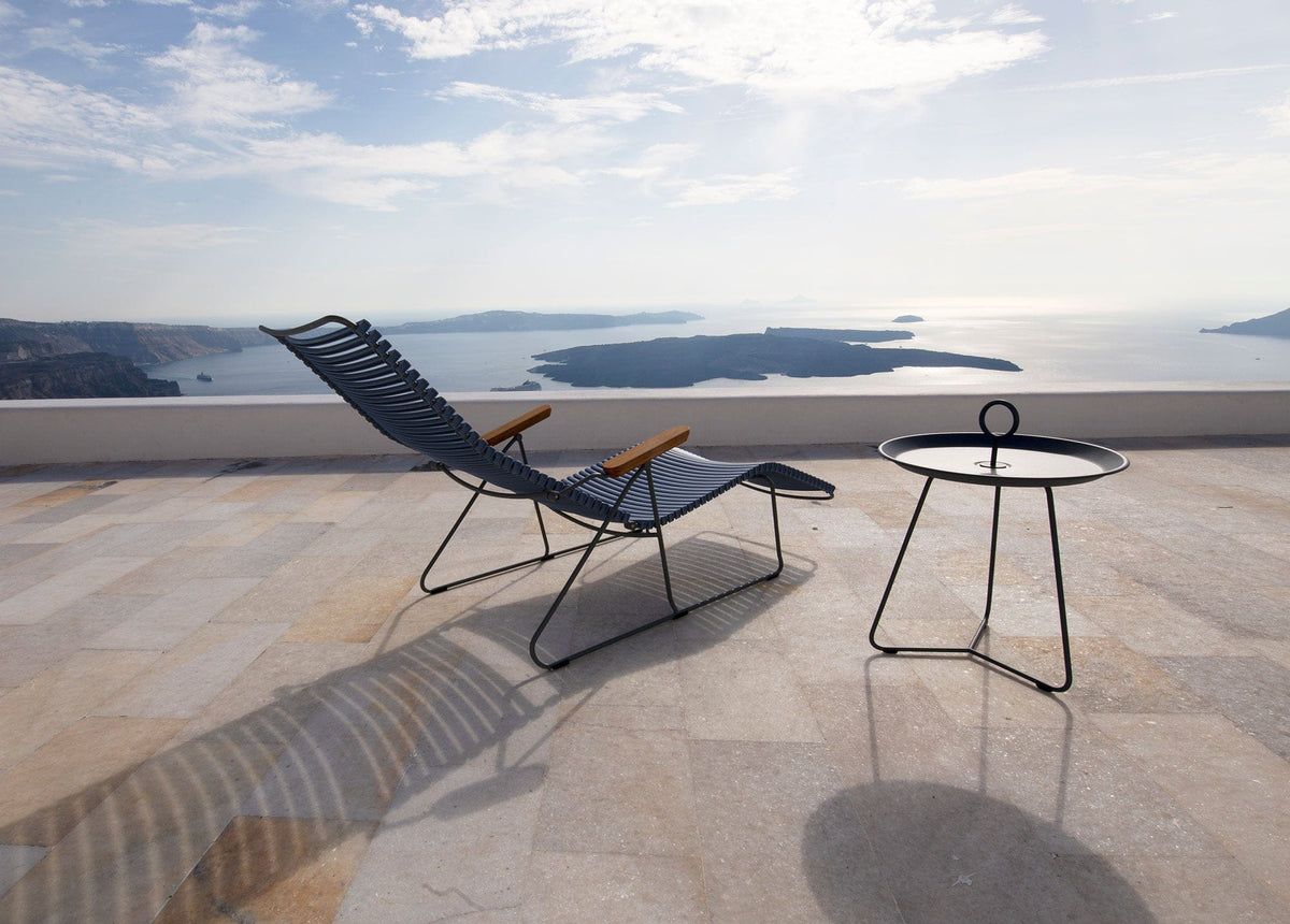 CLICK black sunlounger with black side table overlooking the sea